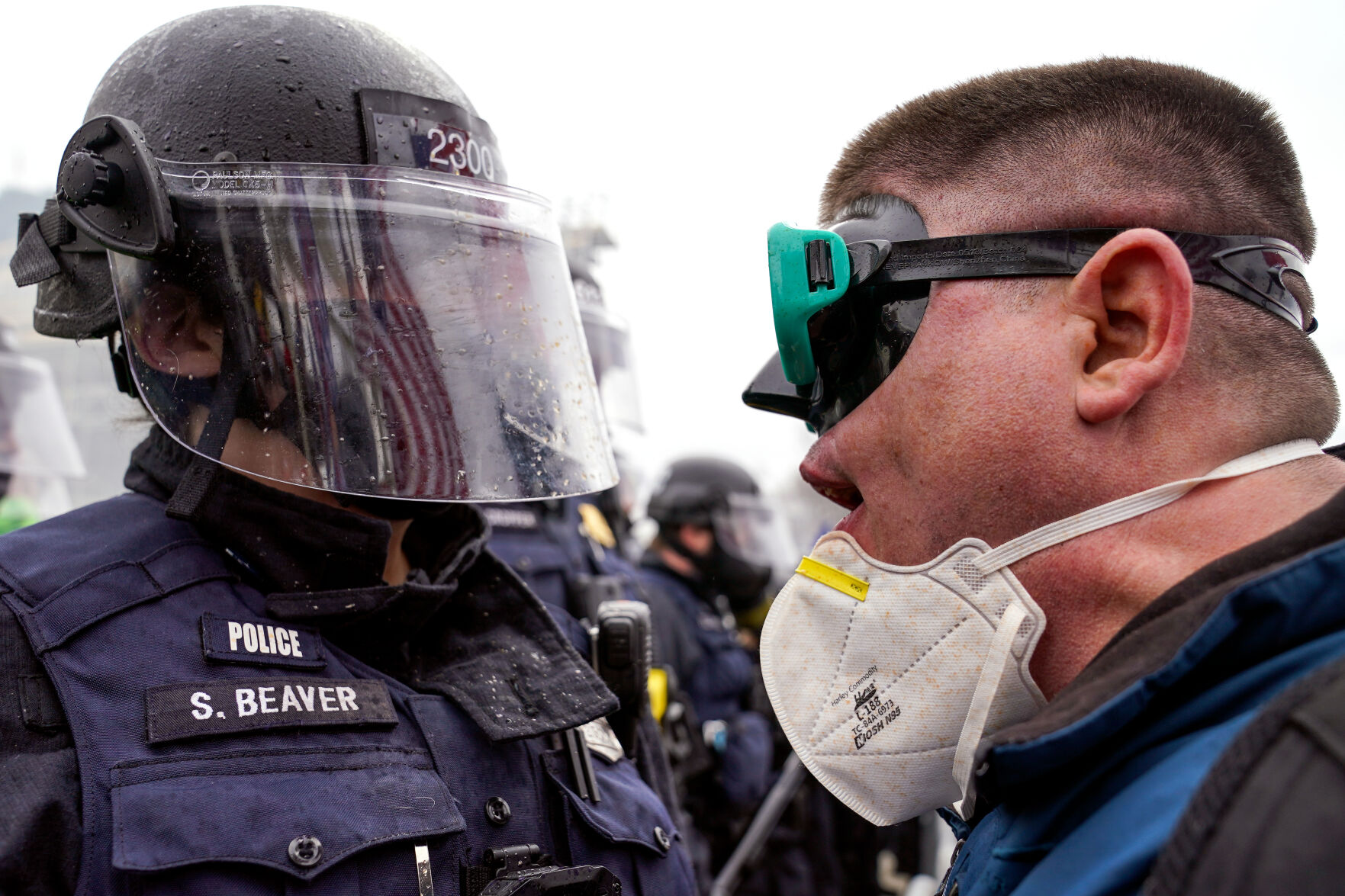 A demonstrator talks to police over a barrier